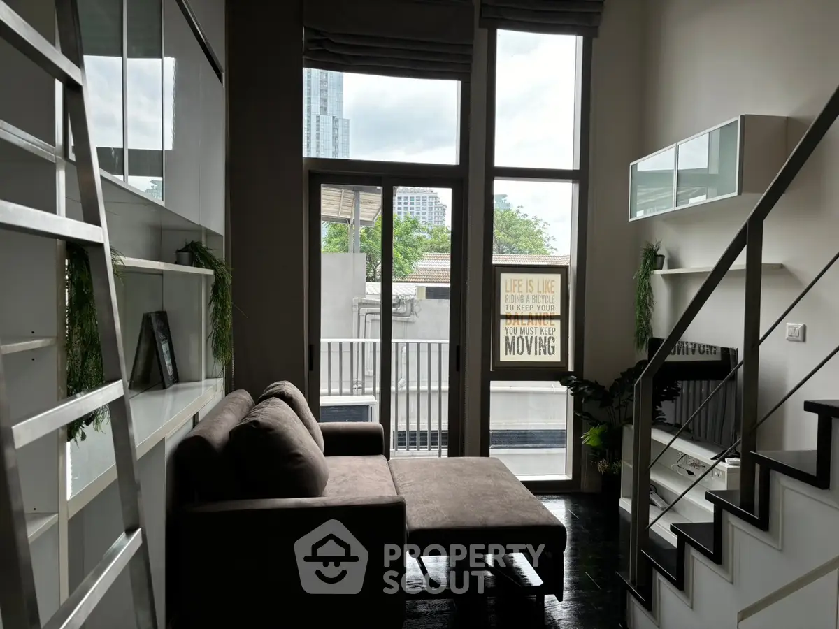 Modern loft living room with high ceiling and balcony view