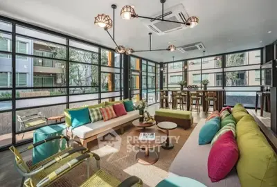 Spacious modern living room with colorful decor and large windows offering a stunning view.