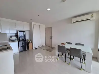 Modern open-layout kitchen and dining area with sleek design and ample natural light.