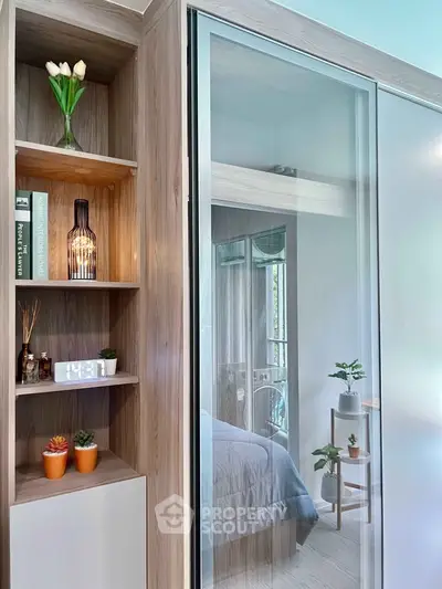 Modern bedroom with glass sliding door and stylish shelving unit
