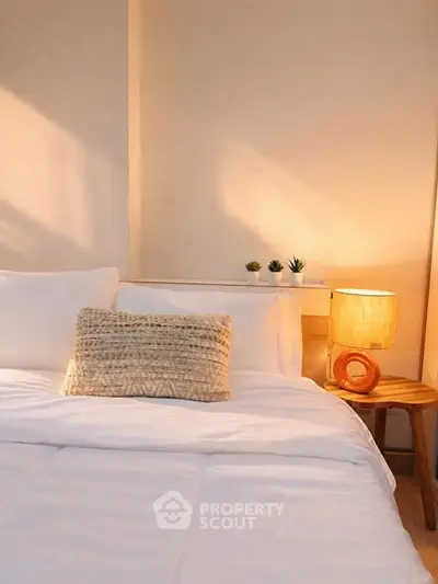 Cozy bedroom with soft lighting and stylish decor, perfect for relaxation.