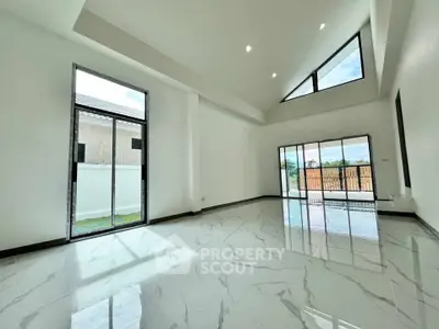 Spacious modern living room with high ceilings and large windows