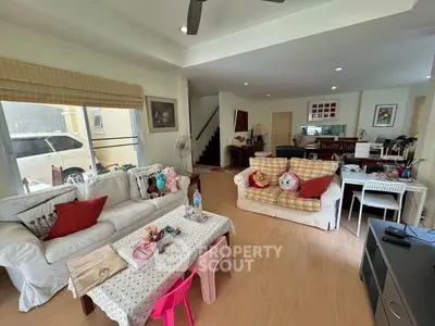 Spacious living room with cozy seating and natural light, perfect for family gatherings.