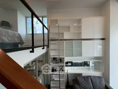 Modern loft apartment with mezzanine bedroom and sleek storage solutions