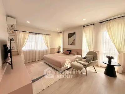 Spacious and bright bedroom with modern decor and large windows