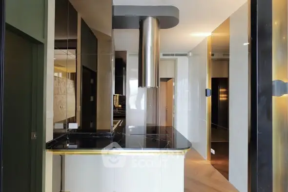 Modern kitchen with sleek black countertops and stainless steel accents