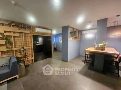 Modern open-concept living and dining area with stylish decor and ambient lighting.