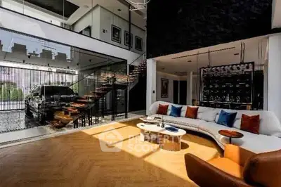 Luxurious modern living room with stylish decor and open layout, featuring a unique car display area.