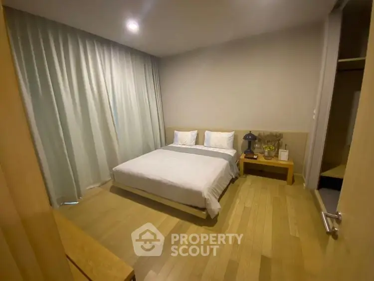 Cozy bedroom with wooden flooring and modern decor