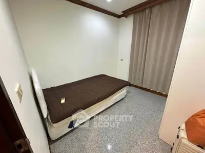 Cozy bedroom with single bed and minimalist decor, perfect for a peaceful retreat.
