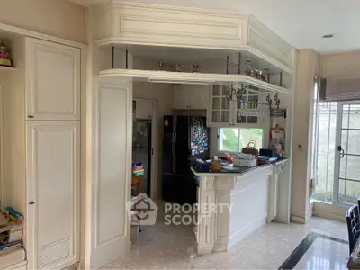 Elegant kitchen with closed layout and stylish cabinetry in a bright home interior.