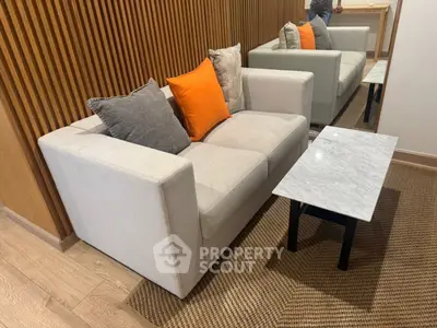 Modern living room with stylish sofa and marble coffee table