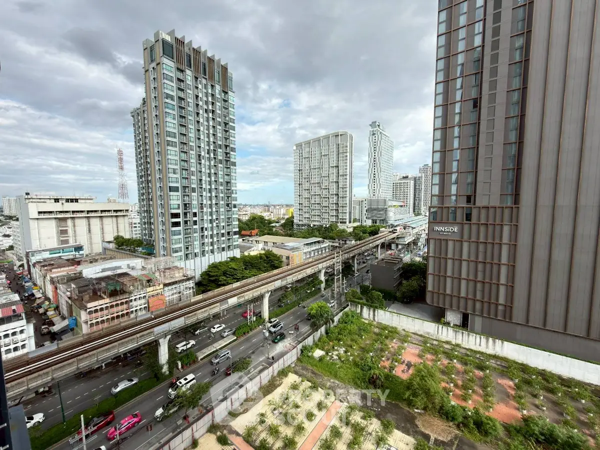 Stunning cityscape view from a high-rise building with modern architecture and lush greenery.