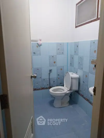 Compact bathroom with blue tile design and standard fixtures