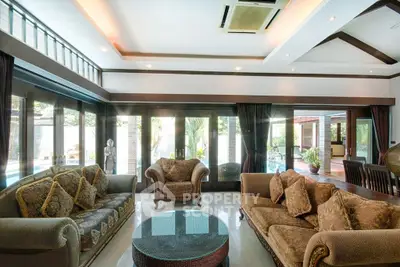 Luxurious living room with elegant furniture and pool view, perfect for relaxation and entertainment.