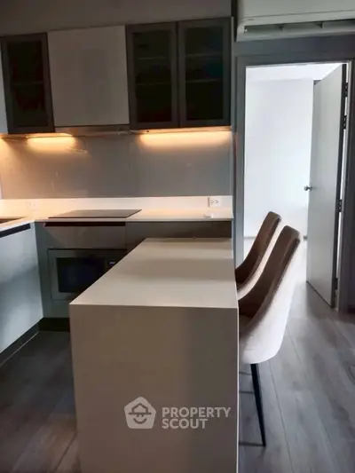 Modern kitchen with sleek cabinetry and breakfast bar seating