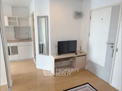 Modern apartment interior with compact kitchen and cozy living area.