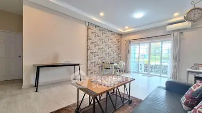 Spacious living room with modern decor and large windows offering natural light.