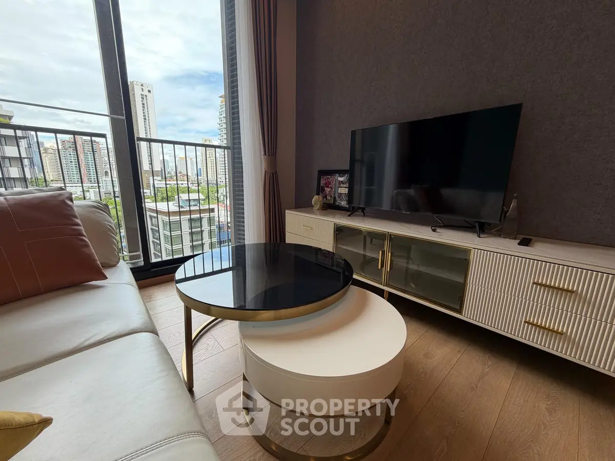 Modern living room with stylish furniture and city view from balcony