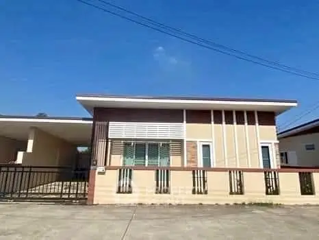 Modern single-story house with sleek design and gated driveway in sunny neighborhood.