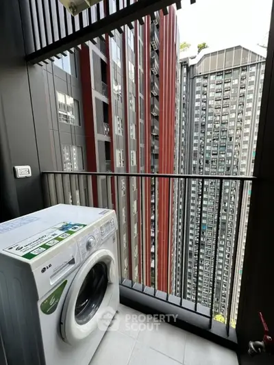 Modern apartment balcony with washing machine and city view