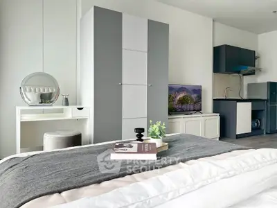 Modern bedroom with stylish decor and compact kitchen area