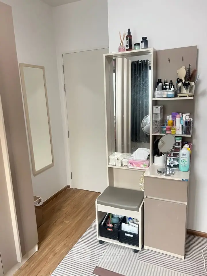 Stylish bedroom corner with modern vanity and ample storage space.