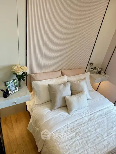 Elegant bedroom with modern decor, featuring a cozy bed, stylish side tables, and decorative accents.