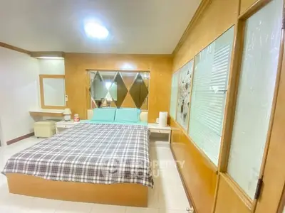 Spacious bedroom with cozy bed and modern decor, perfect for relaxation and comfort.