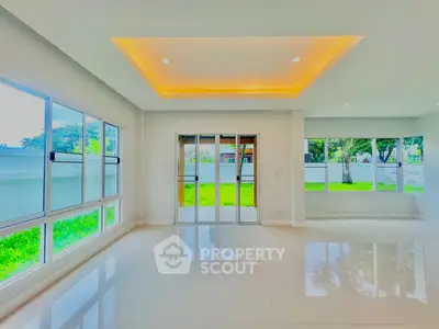 Spacious modern living room with large windows and garden view