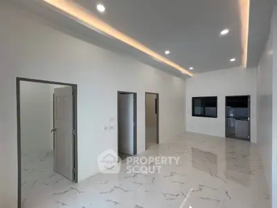 Spacious modern interior with marble flooring and recessed lighting, ideal for customization.