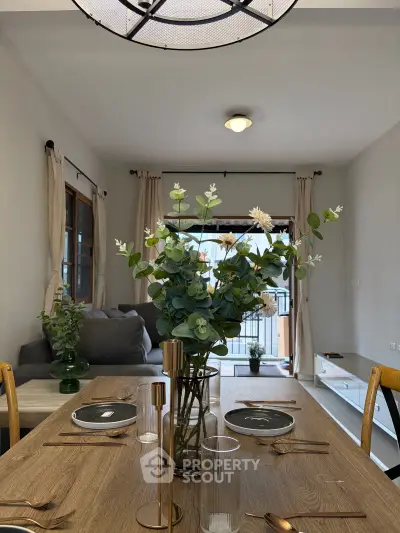 Elegant dining area with modern decor and natural light, featuring a stylish table setting and cozy seating.