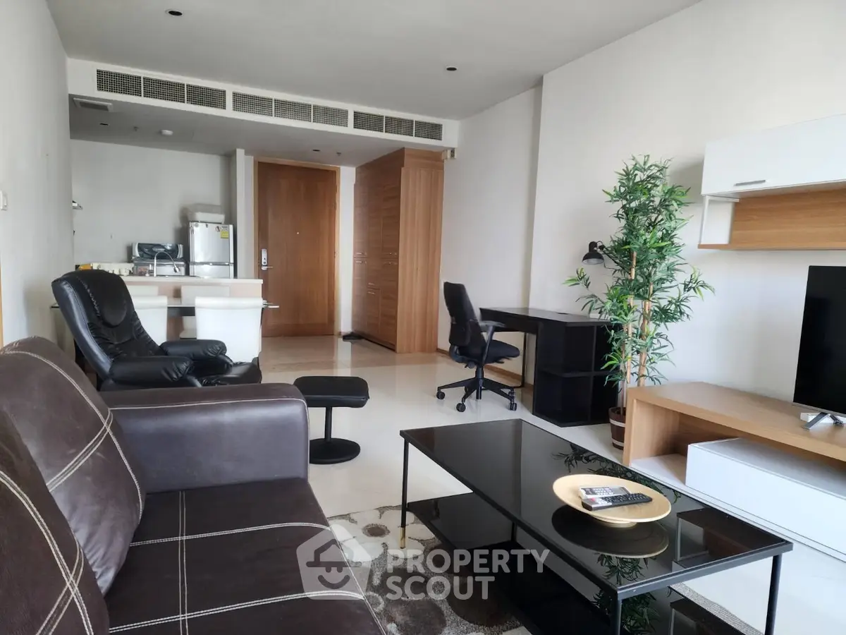 Modern living room with sleek furniture and open kitchen layout, perfect for urban living.