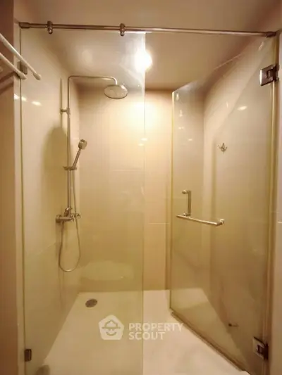 Modern bathroom with glass shower enclosure and sleek fixtures