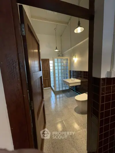 Spacious bathroom with modern fixtures and stylish lighting