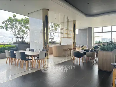 Luxurious open-plan living area with modern dining and seating, featuring panoramic city views and elegant decor.