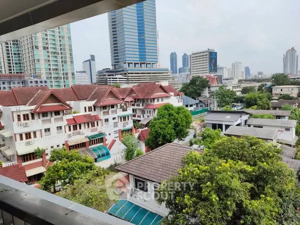 Stunning cityscape view from a high-rise balcony showcasing modern and traditional architecture.