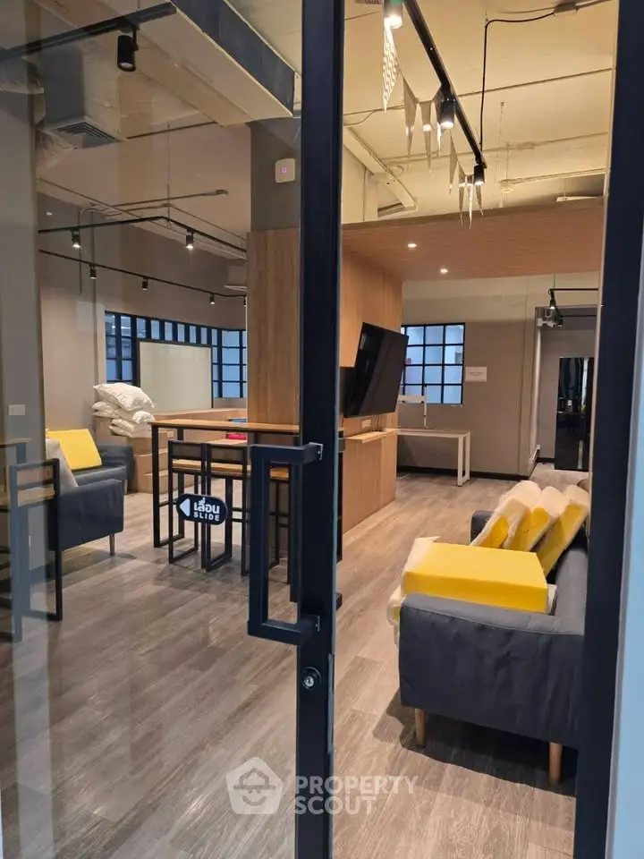 Modern living room with stylish furniture and open layout, featuring sleek design and cozy ambiance.