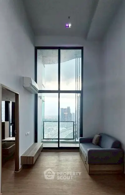 Modern living room with floor-to-ceiling windows and city view