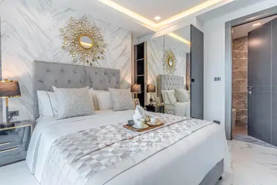 Luxurious bedroom with elegant decor and plush bedding in modern apartment