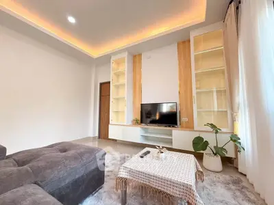 Modern living room with cozy sofa and stylish built-in shelves