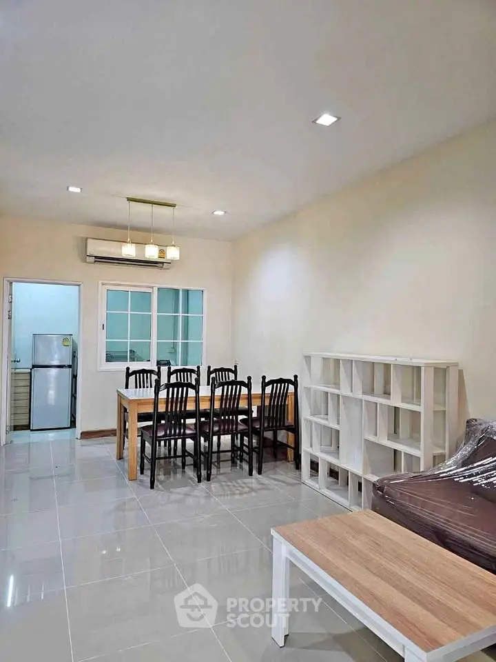 Spacious living room with dining area and modern furniture in a contemporary apartment.