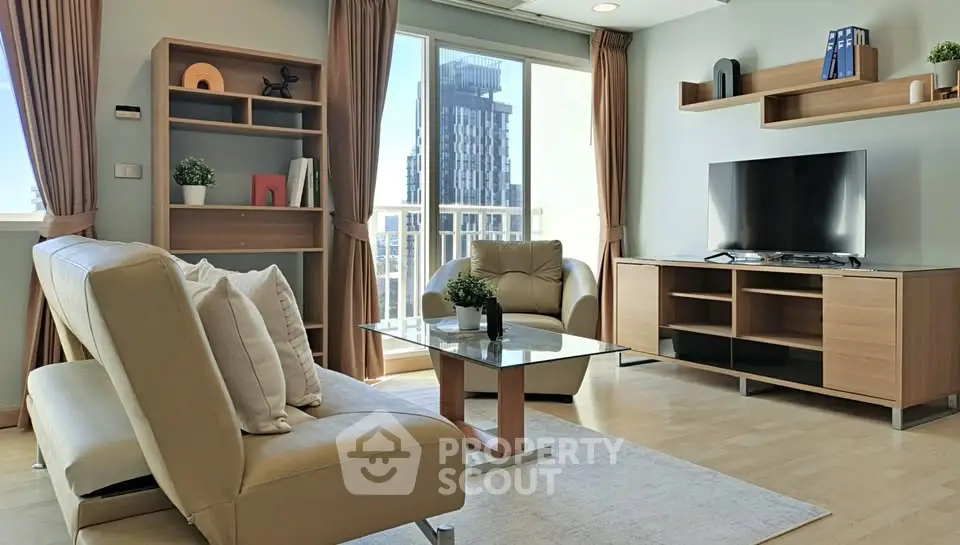 Modern living room with stylish furniture and large windows offering city views.