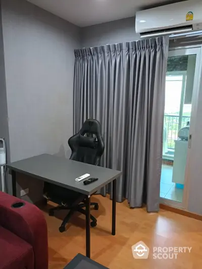 Modern study room with sleek desk and ergonomic chair, featuring a balcony view and air conditioning.