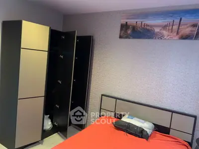 Modern bedroom with stylish wardrobe and beach-themed artwork