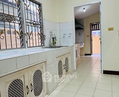 Spacious kitchen with tiled countertops and open layout