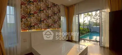 Luxurious bedroom with pool view and vibrant wallpaper, perfect for relaxation and comfort.