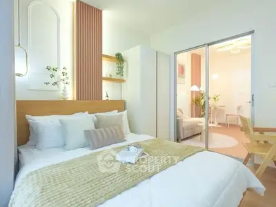 Modern bedroom with stylish decor and sliding glass doors leading to a cozy living area.