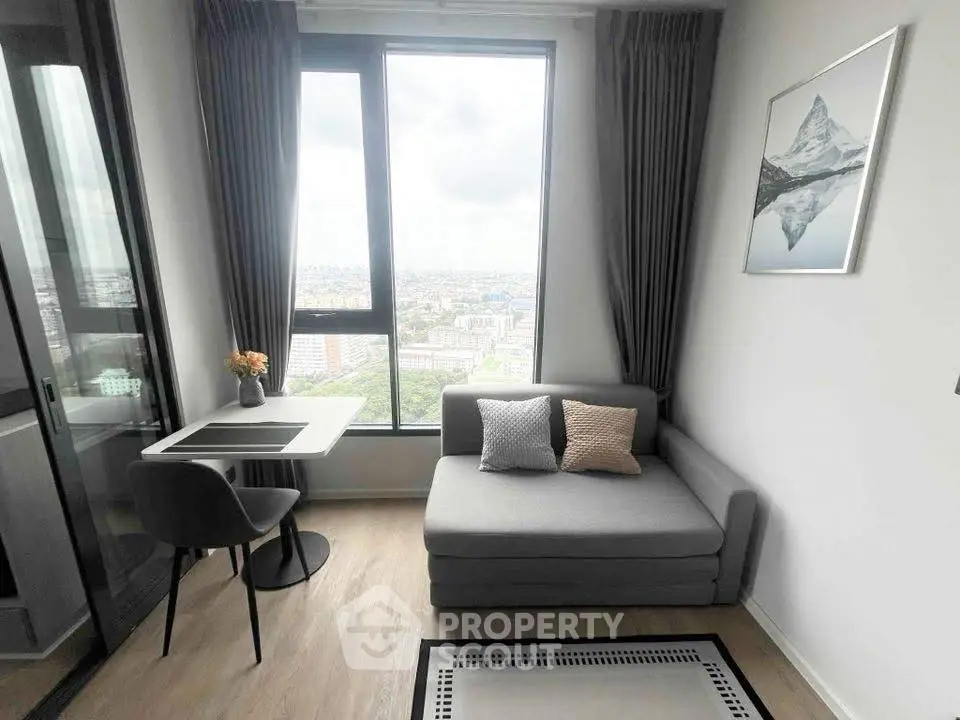 Modern living room with stunning city view, featuring a cozy sofa and dining area.