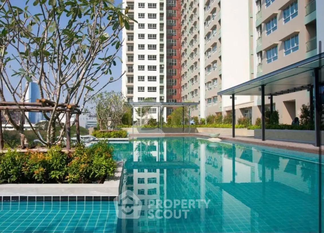 Luxurious apartment complex with stunning pool and lush greenery